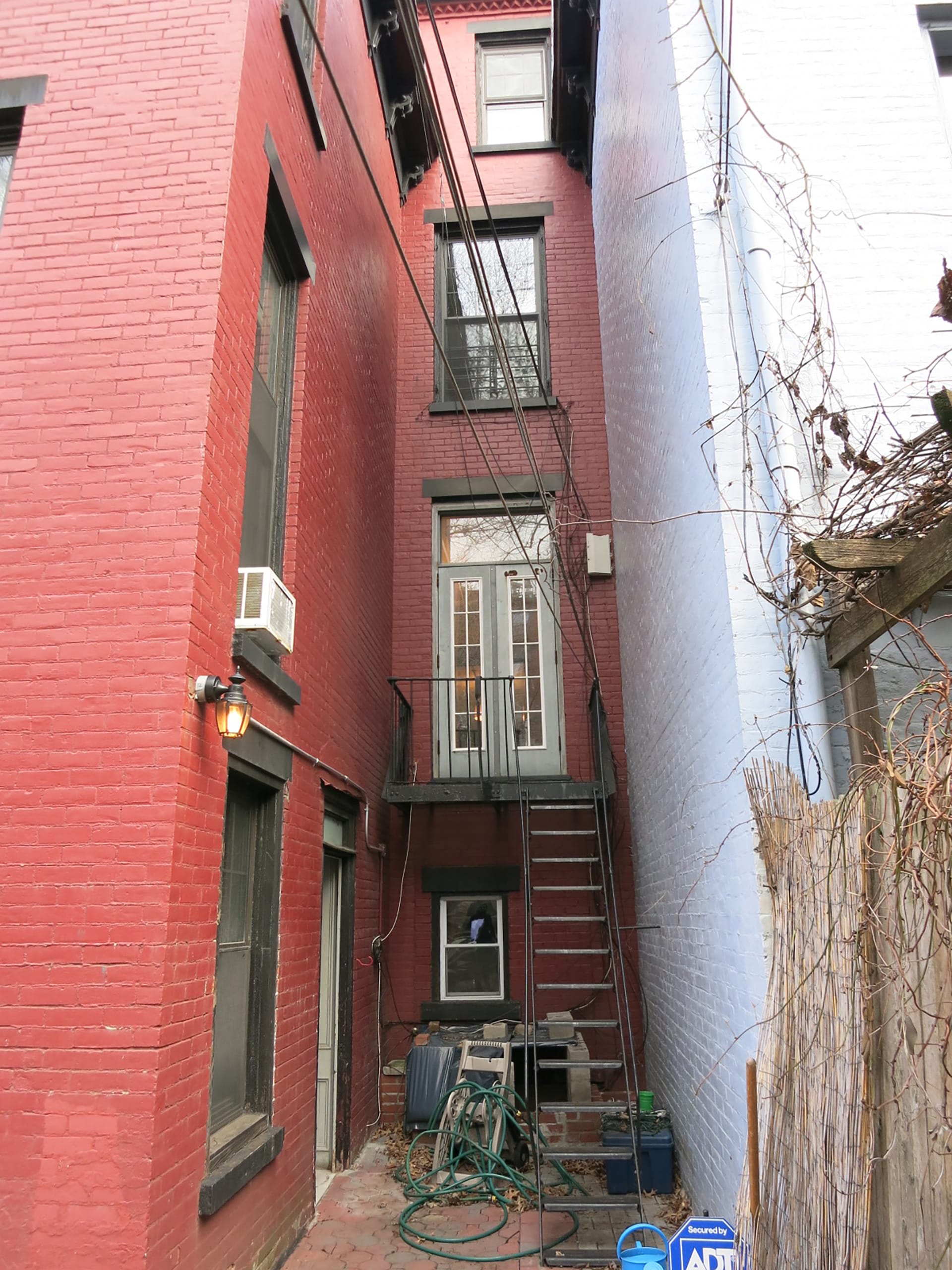Red-painted brick rear façade of a Prospect Heights townhome